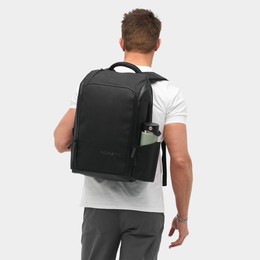 NOMATIC Travel Pack 20L black backpack front view showing multiple compartments and sleek design