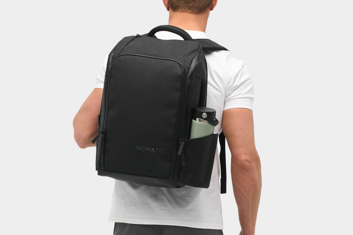NOMATIC Travel Pack 20L black backpack front view showing multiple compartments and sleek design