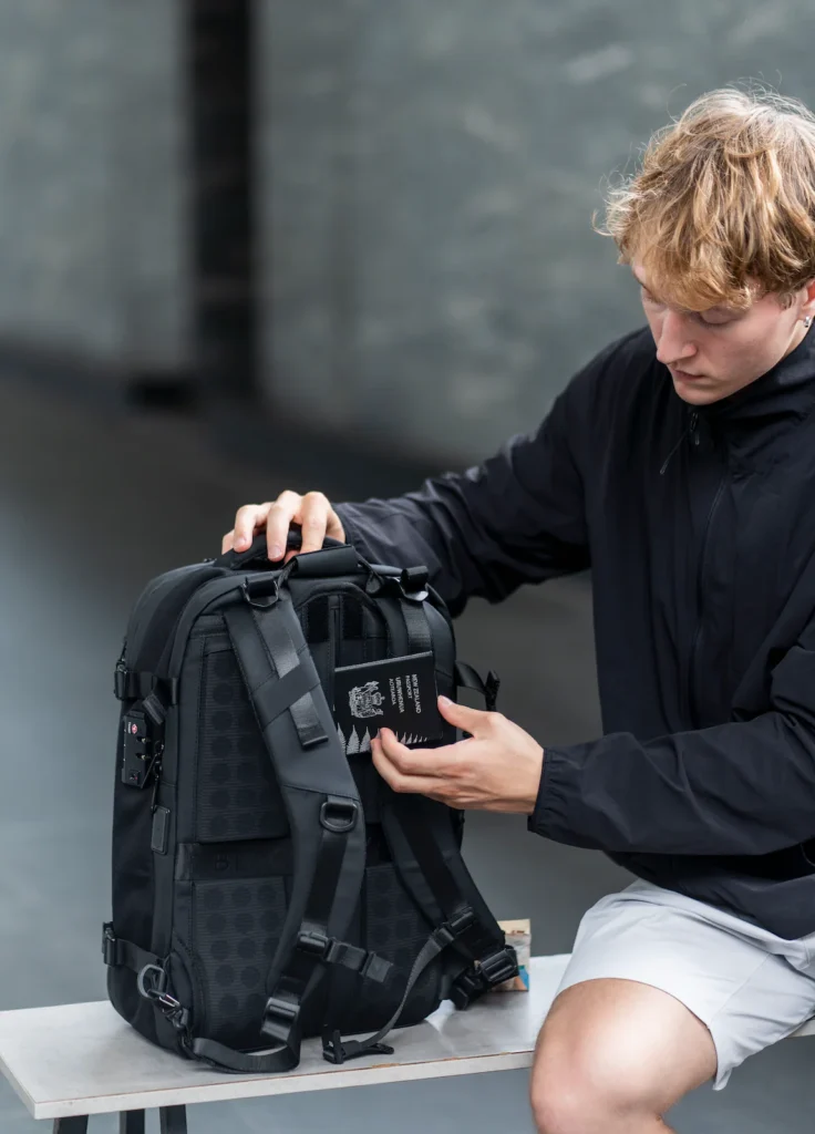 Person wearing Black Voyage Zephyr Backpack while hiking, demonstrating comfortable fit and ergonomic shoulder straps